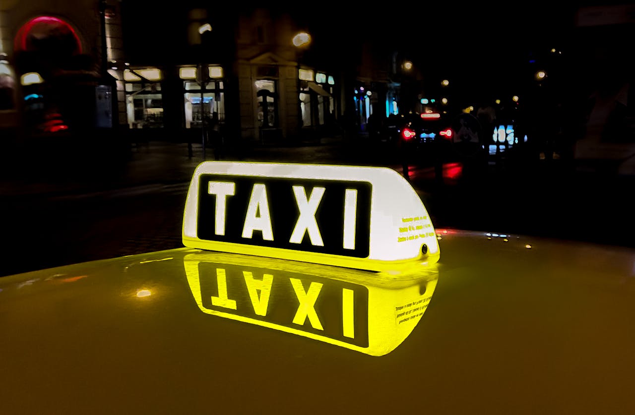 creative-03 Close-up of a glowing taxi sign reflecting in the night city street, capturing urban nightlife.