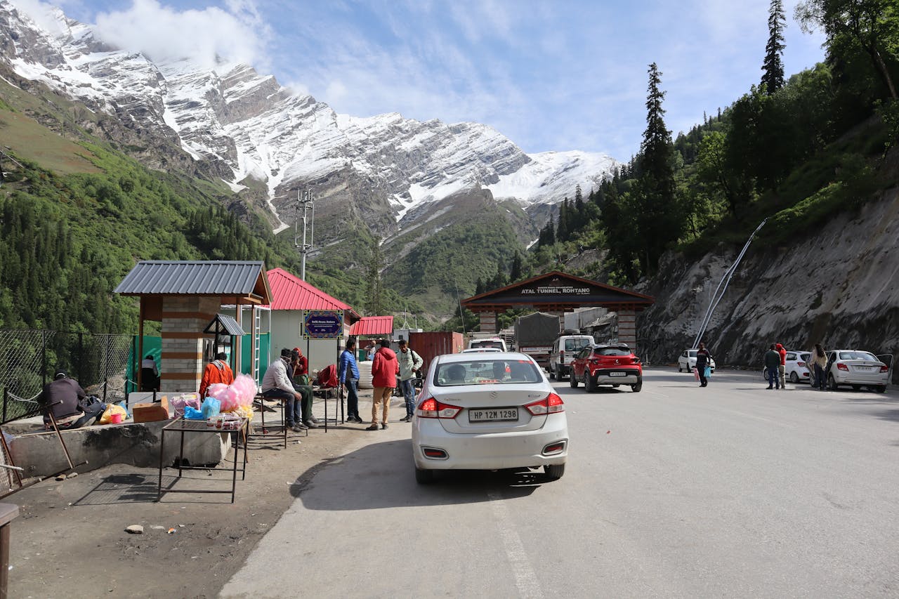 creative-02 Bustling scene near Atal Tunnel, Ladakh with mountains, snow, and local vendors.