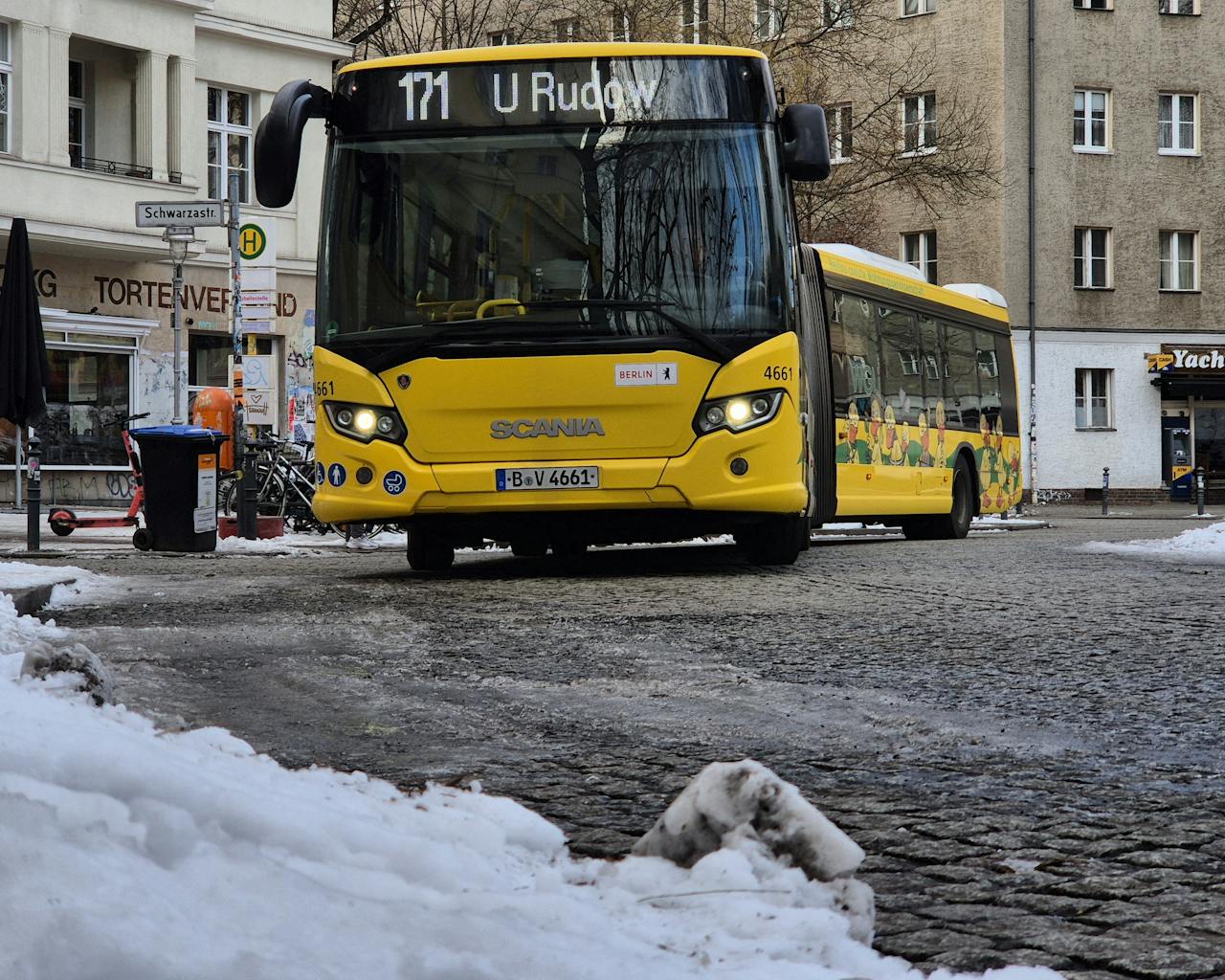 creative-01 Yellow Berlin city bus in snowy urban winter scene.
